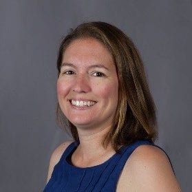 Wendy Leblanc smiles at the camera wearing a blue shirt.