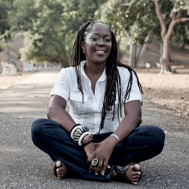 lesley-ann noel Dr. Lesley-Ann Noel smiling and sitting in front of trees.