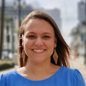 Abby Lukens smiling wearing a blue shirt.