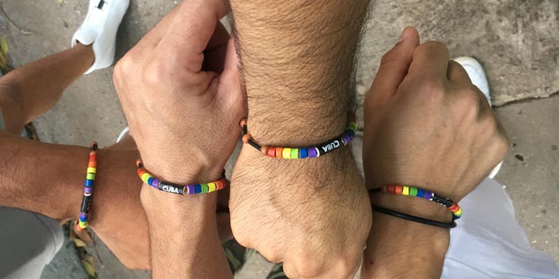 Hands being held out with matching "Cuba" bracelets