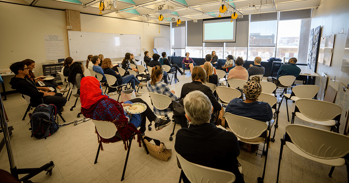 Researchers And Scholars Sitting In The Taylor Center Space, Attending A Social Innovation Panel.