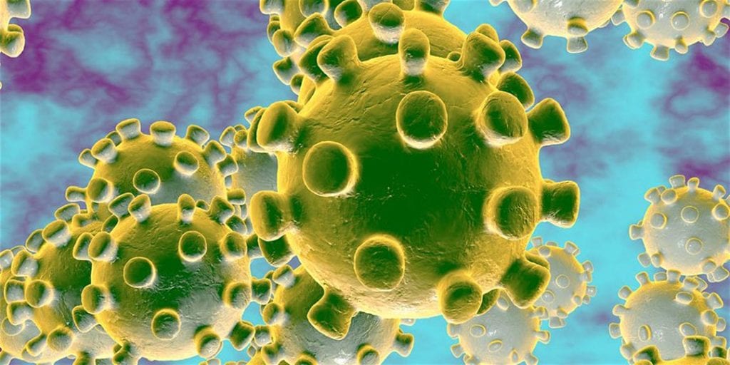An illustration of viruses in green over a blue and purple background.