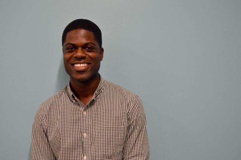 Kwasi Agyeman Kwasi Agyeman is smiling, wearing a gingham button-up shirt.