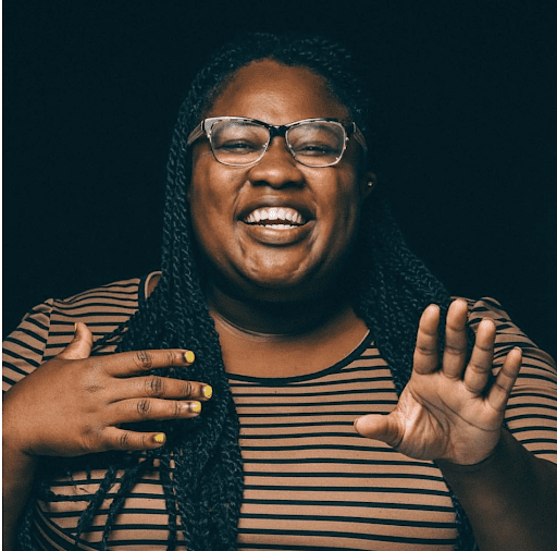 Breanna Harvey smiling wearing a striped shirt.