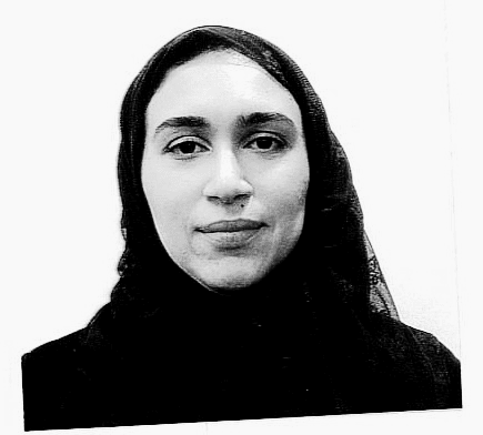 Shaymaa-Abdalal Woman smiling wearing black clothes in front of a white wall.