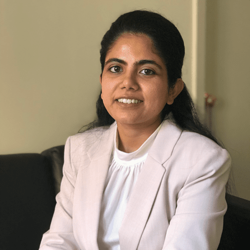 Woman smiling wearing a blazer.
