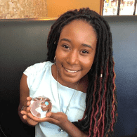 niesha-ford Woman smiling wearing a white shirt.